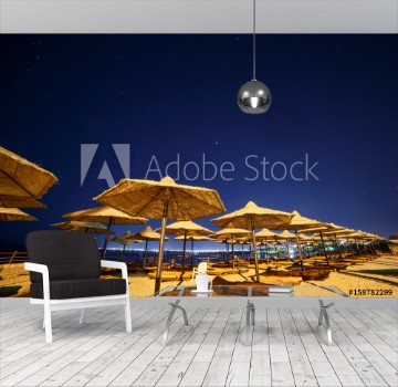 Picture of sunshade beach umbrellas against night sky in Egypt